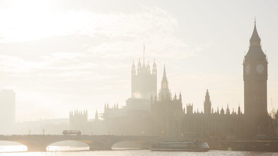 View from the Thames river of Big Ben - Clock Tower - and Houses of Parliament and Westminster bridge in London