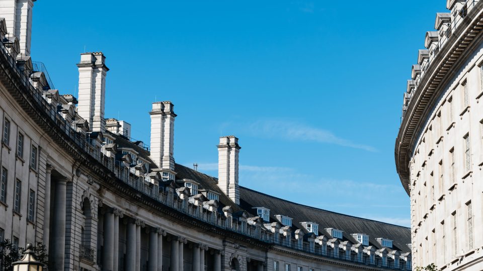 Old buildings in Regent Street in the city of Westminster in London. View against blue sky